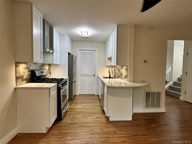 a view of kitchen with cabinets and wooden floor