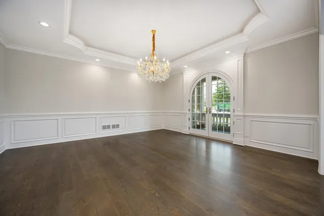 a living room with stainless steel appliances furniture a bathtub and a view of kitchen