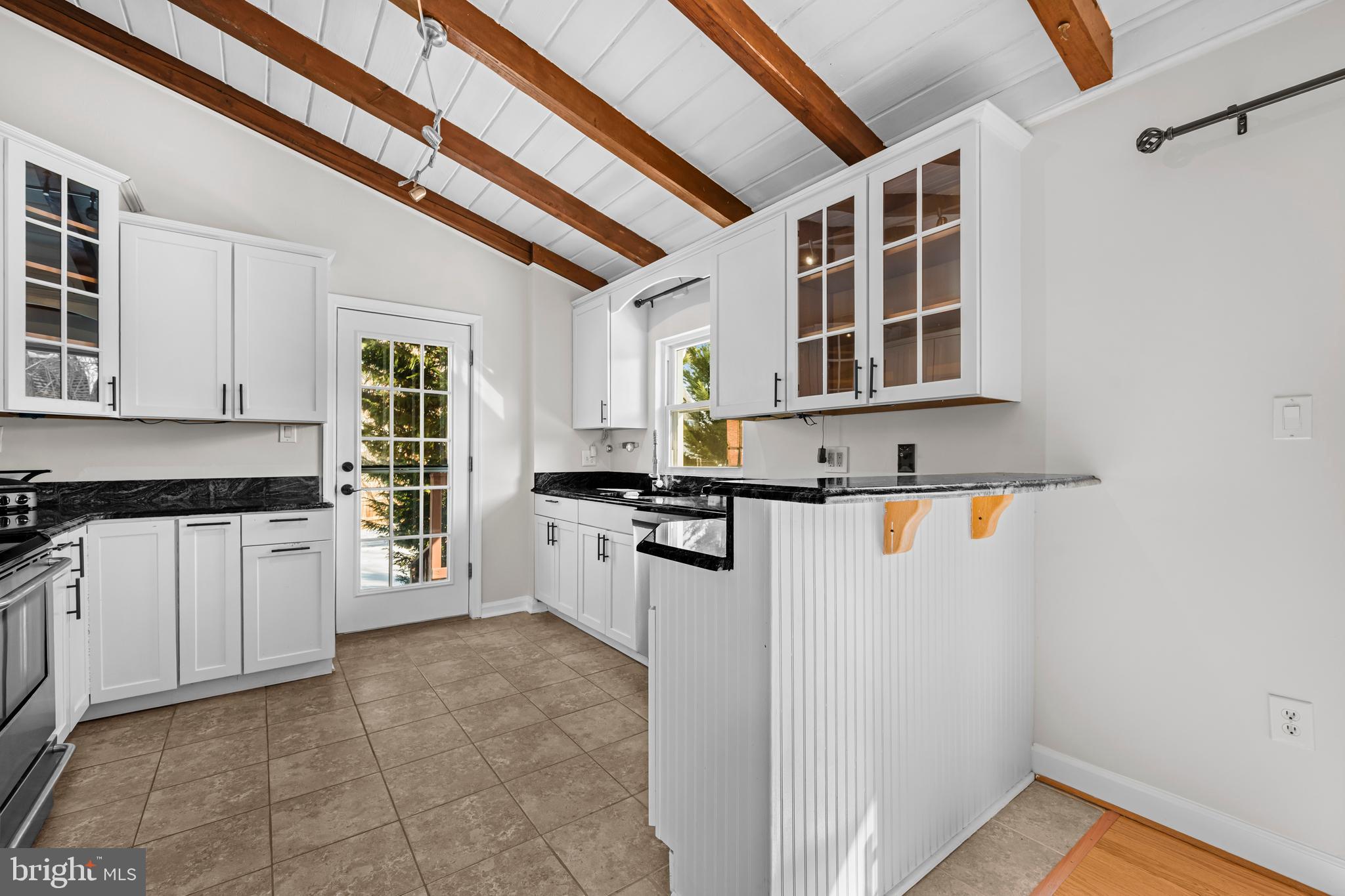 6813 Derrell Court Alexandria, VA 22307 - Photo 11 of 34 a kitchen with stainless steel appliances granite countertop a stove and a refrigerator