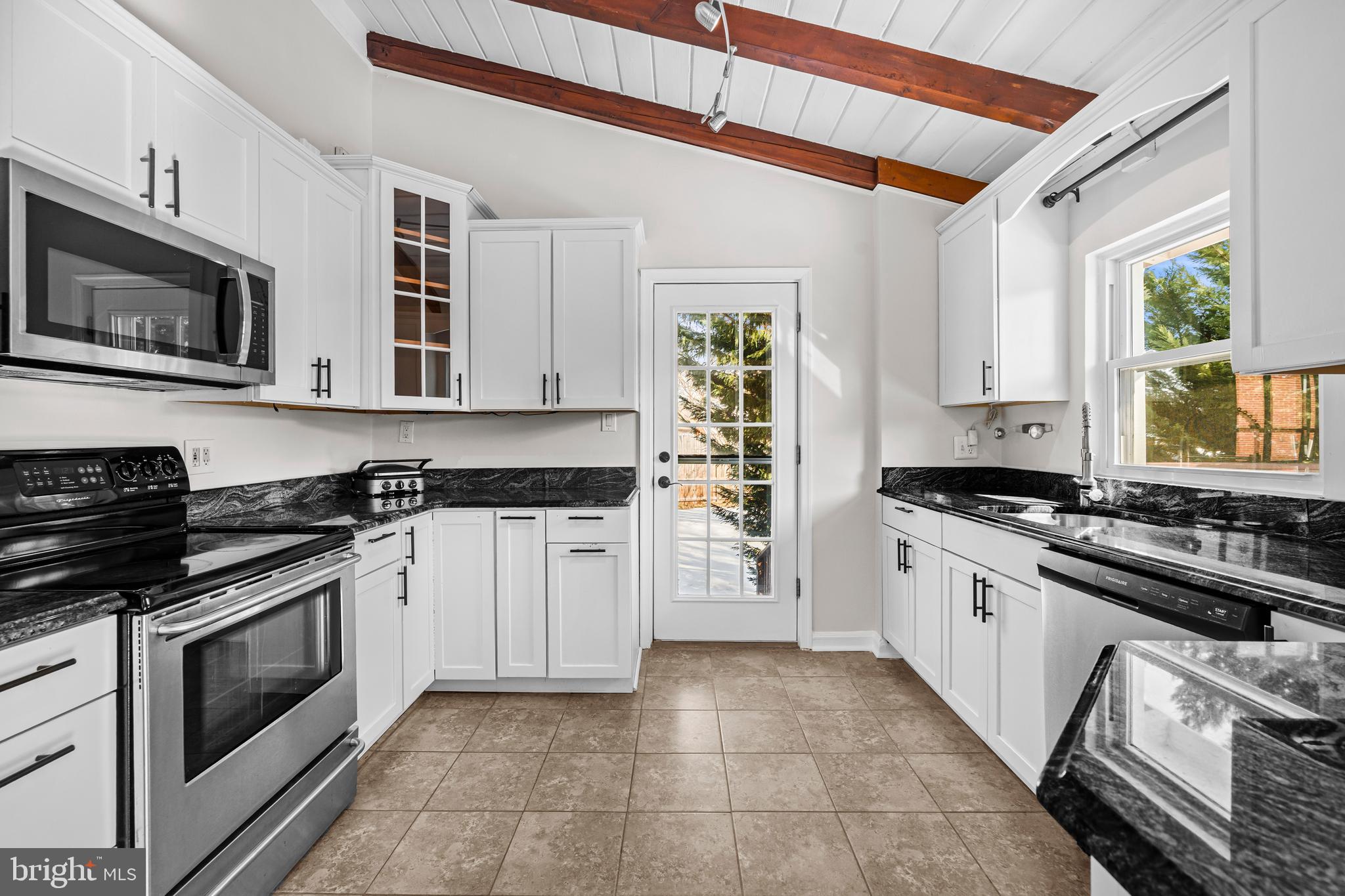 6813 Derrell Court Alexandria, VA 22307 - Photo 12 of 34 a kitchen with stainless steel appliances granite countertop a stove and a sink