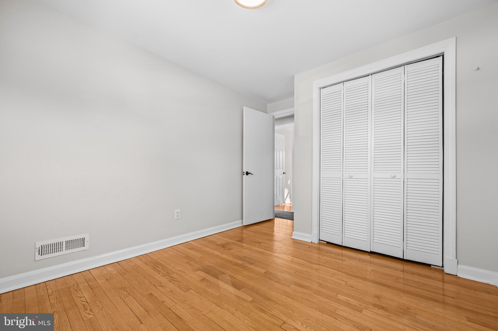 6813 Derrell Court Alexandria, VA 22307 - Photo 20 of 34 a view of an empty room with wooden floor and a window