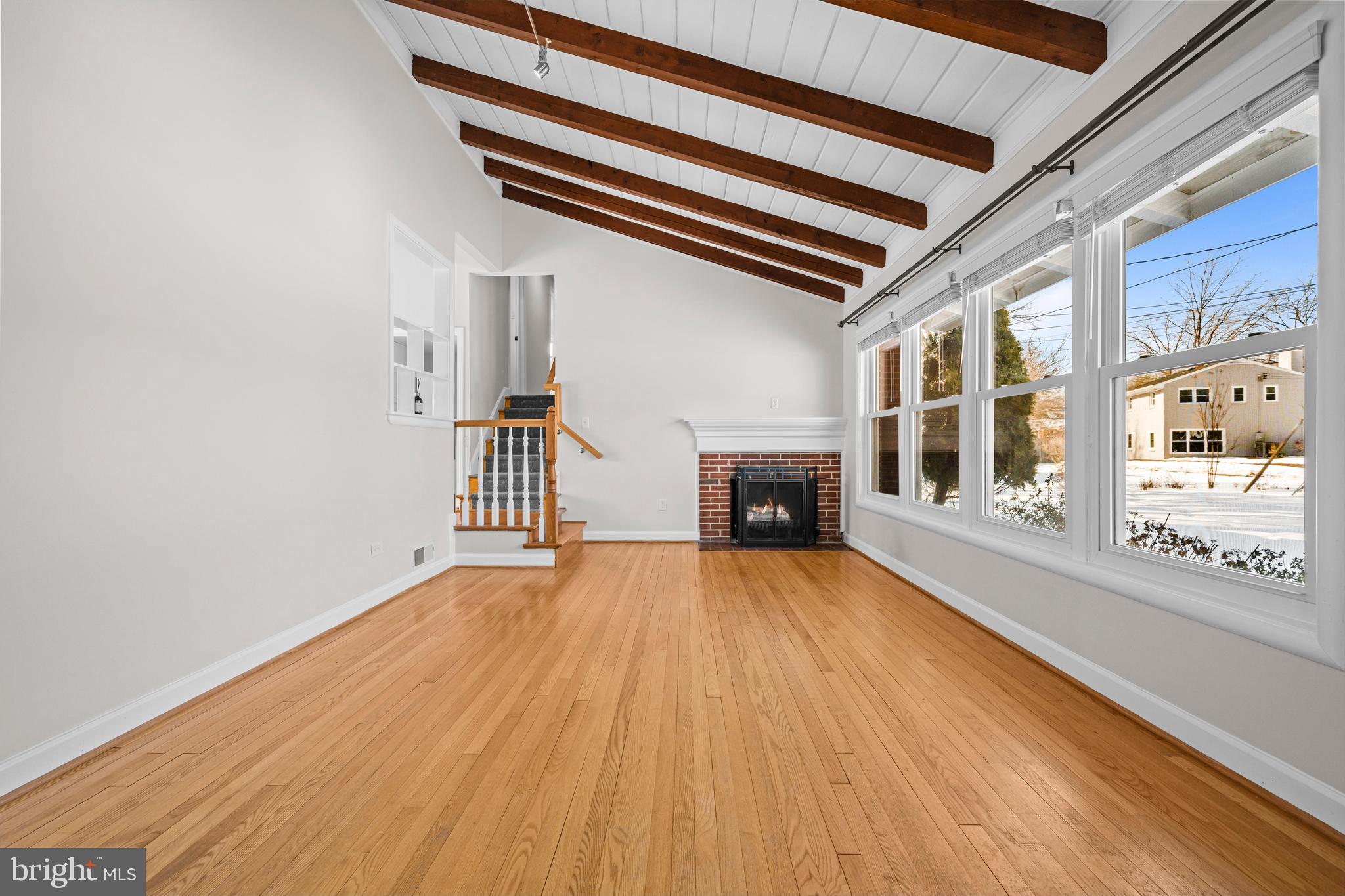 6813 Derrell Court Alexandria, VA 22307 - Photo 6 of 34 a view of an empty room with wooden floor and a window