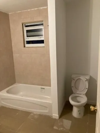 a bathroom with a toilet and a bathtub