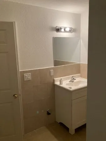 a bathroom with a sink a vanity and mirror