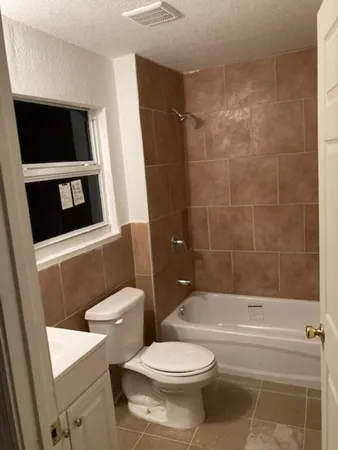 a bathroom with a toilet a sink and bathtub