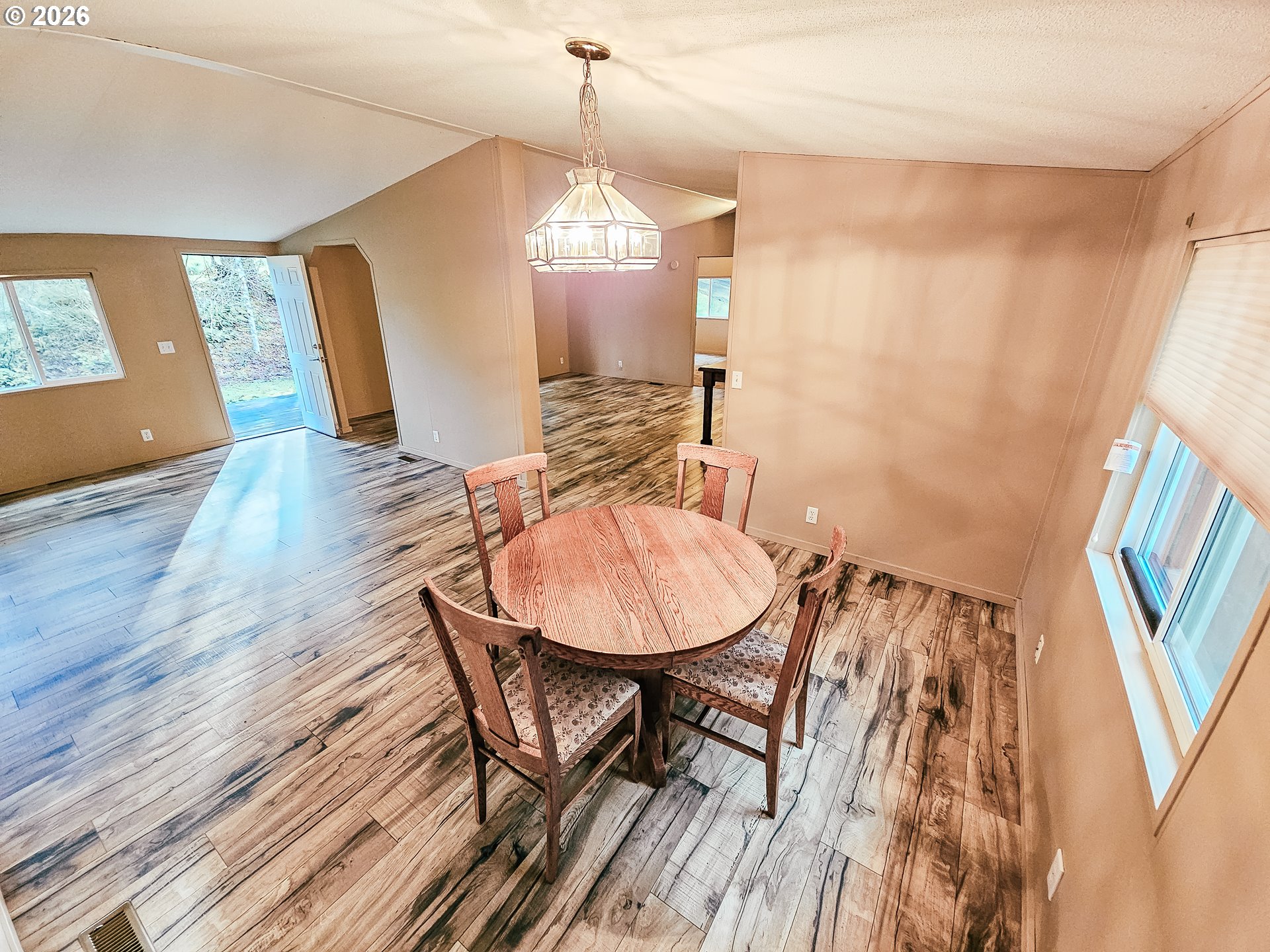 295 Easy Street Road Silverlake, WA 98645 - Photo 21 of 42 a view of a dining room with furniture and wooden floor