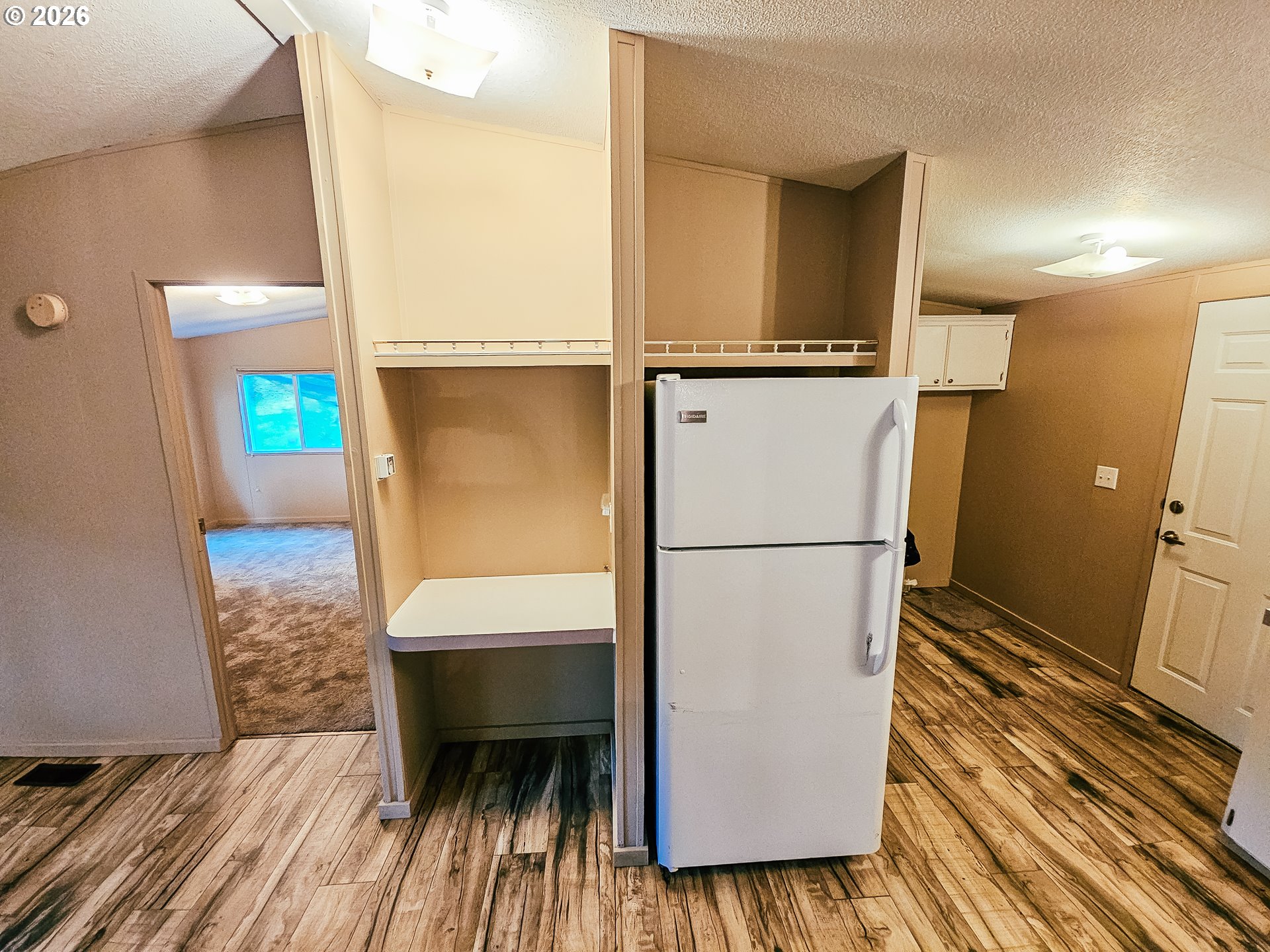 295 Easy Street Road Silverlake, WA 98645 - Photo 3 of 42 a hallway with sliding door and wooden floor