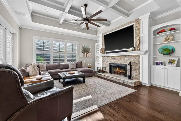 a living room with furniture a flat screen tv and a fireplace