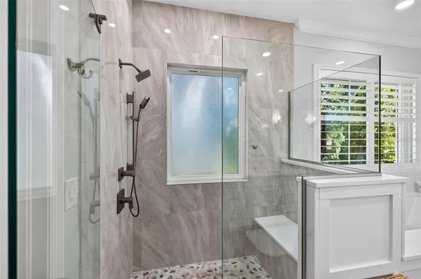 a bathroom with a shower and a tub