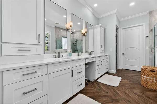 a spacious bathroom with double vanity sink a mirror and a shower