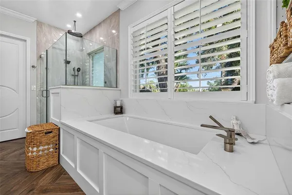 a bathroom with a tub and a shower