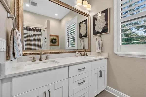 a bathroom with a double vanity sink and a mirror