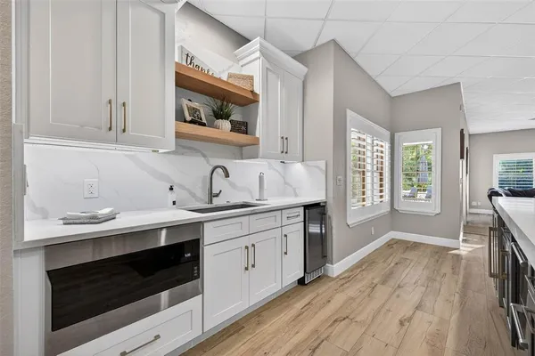 a kitchen with a sink stove and cabinets