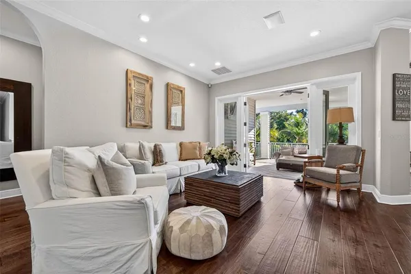 a living room with furniture and a wooden floor