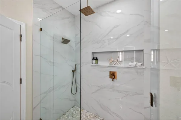 a bathroom with a shower and a mirror