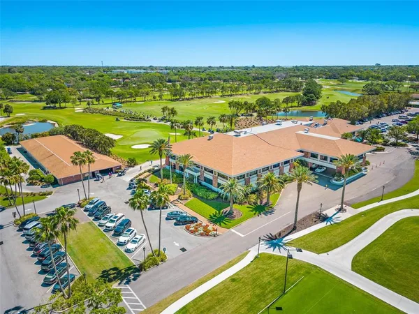 an aerial view of residential houses with outdoor space and ocean view
