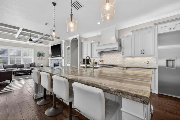 a kitchen with a table chairs refrigerator and cabinets