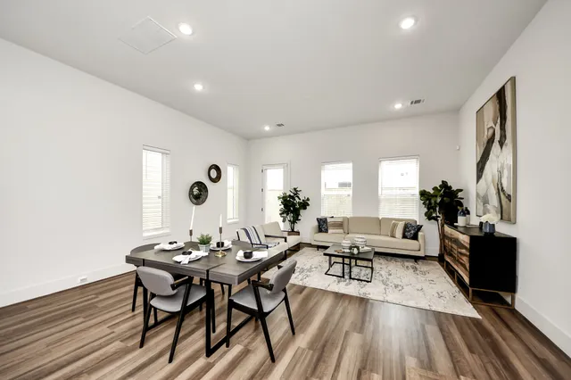 a living room with furniture and wooden floor