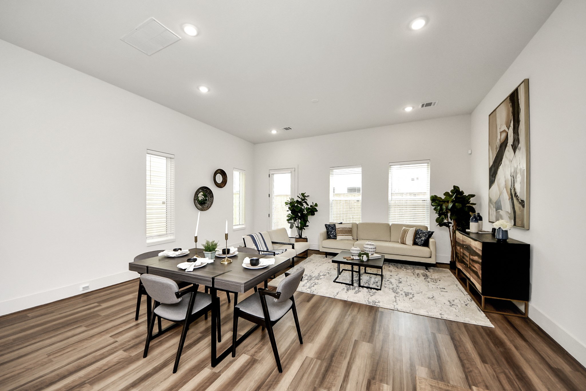 a living room with furniture and wooden floor