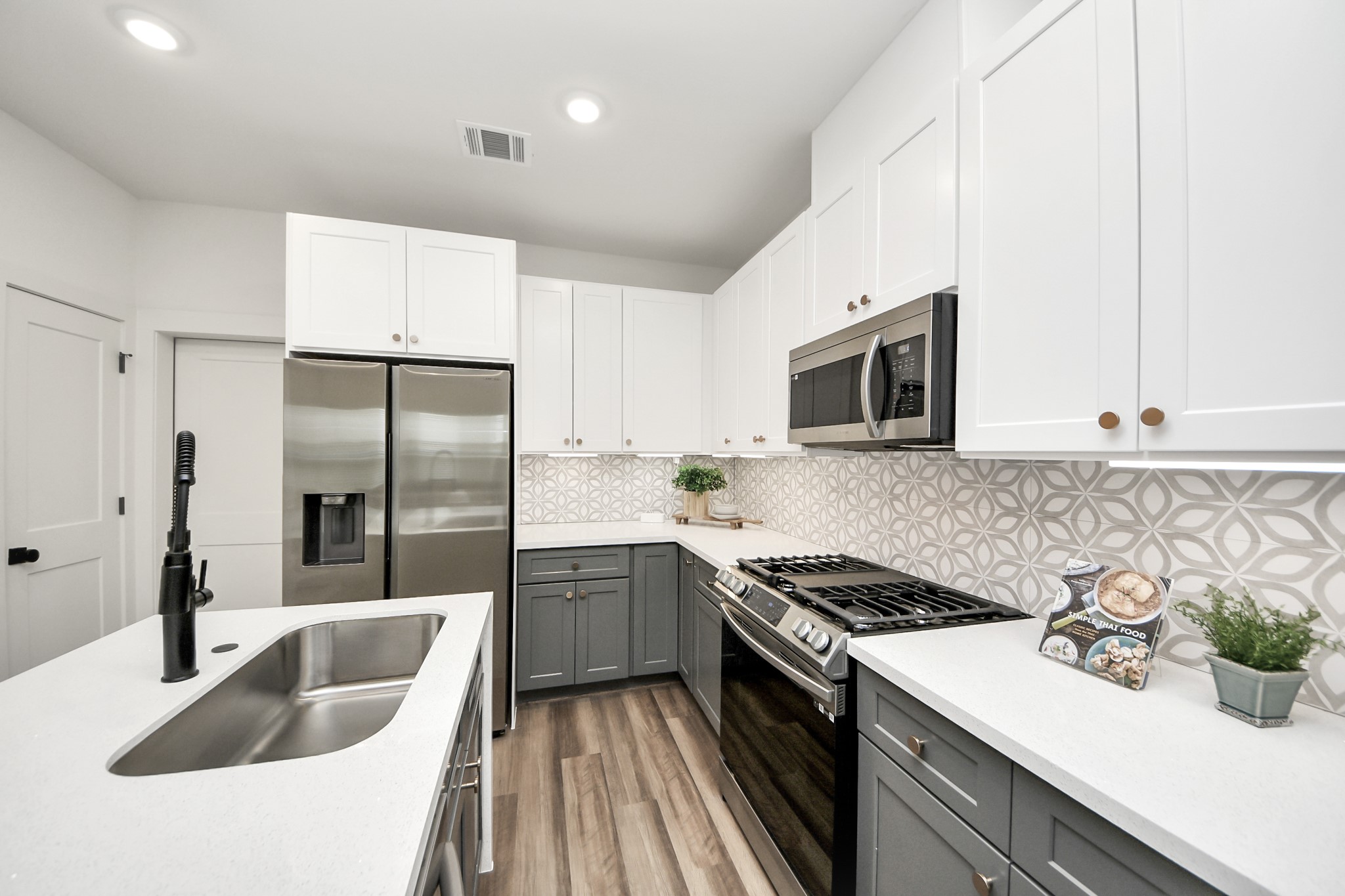 6018 Knox Street Houston, TX 77091 - Photo 19 of 42 a kitchen with sink a microwave and stove