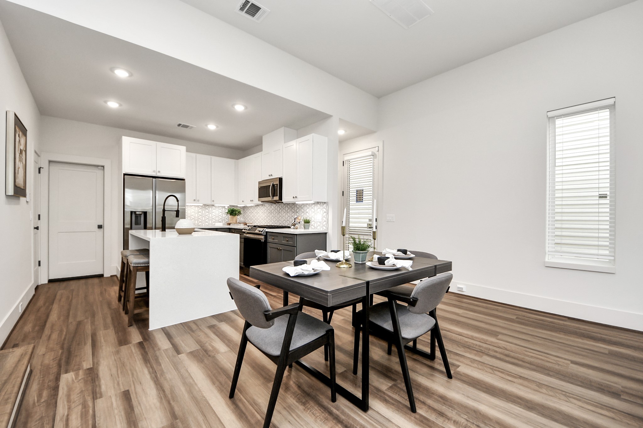 6018 Knox Street Houston, TX 77091 - Photo 9 of 42 a view of a dining room with furniture and wooden floor