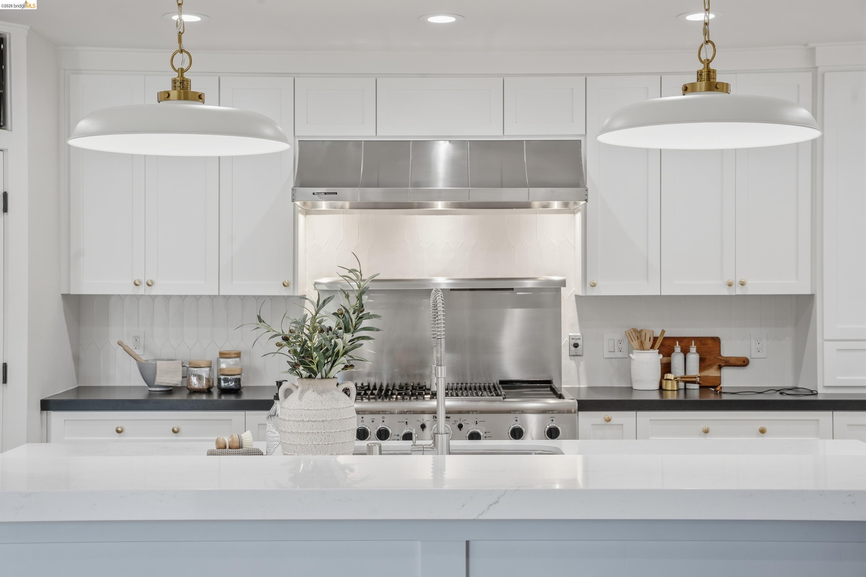 4120 Happy Valley Road Lafayette, CA 94549 - Photo 41 of 48 Gourmet kitchen featuring a stainless steel range with a professional-grade hood, white shaker cabinetry, dark countertops, and a full-height tile backsplash