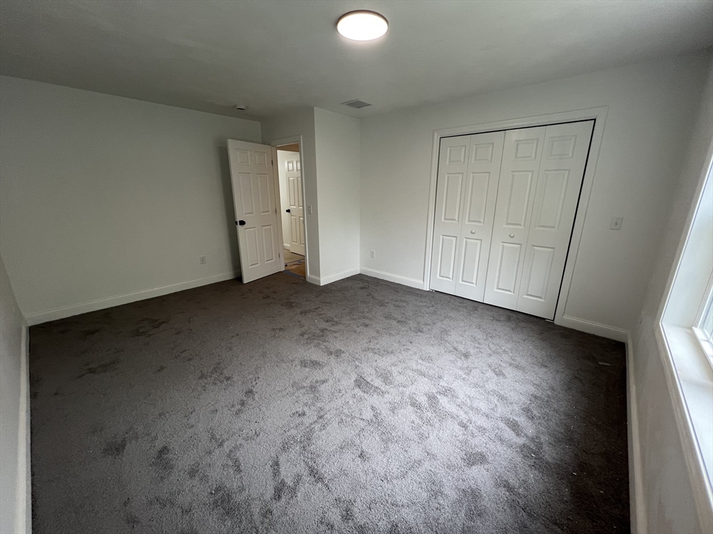 39 Lincoln Street, Unit A / B Webster, MA 01570 - Photo 28 of 33 a view of an empty room and wooden floor