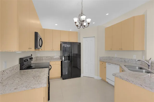 a kitchen with a refrigerator and a sink
