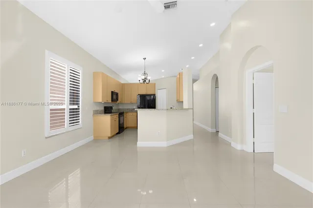 a view of a kitchen with a sink and cabinets