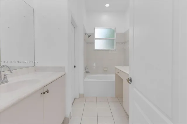 a spacious bathroom with a sink a mirror and a bathtub