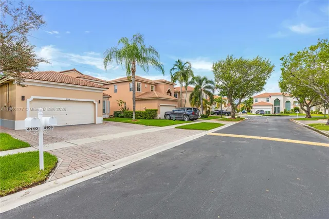 a yellow house with trees in front of it