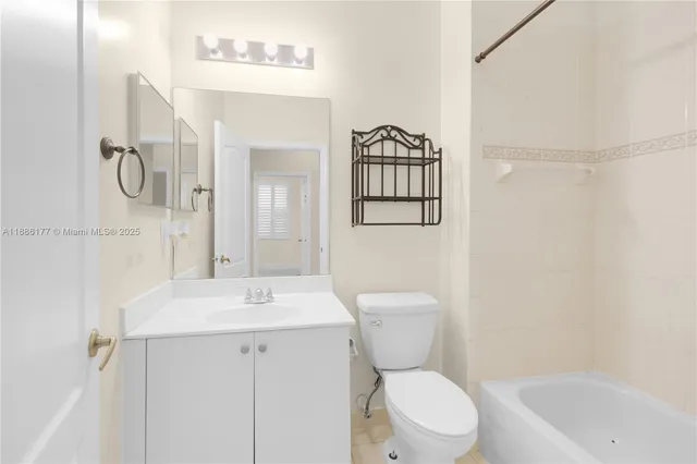 a bathroom with a toilet sink and shower
