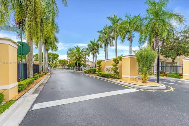 a view of a street with palm trees