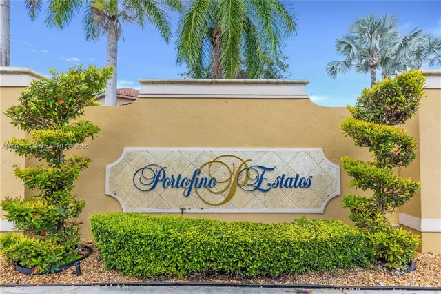 a sign that is on a wall next to a road