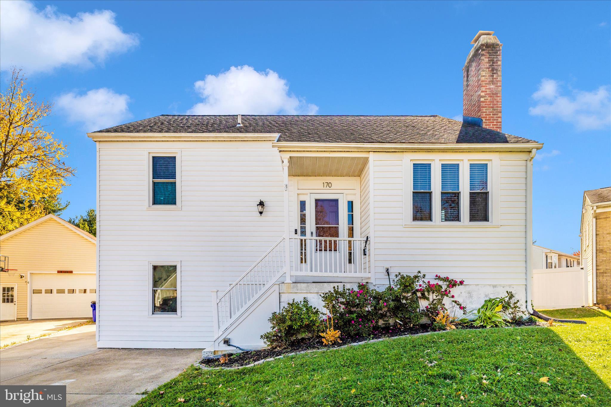 a front view of a house with a garden