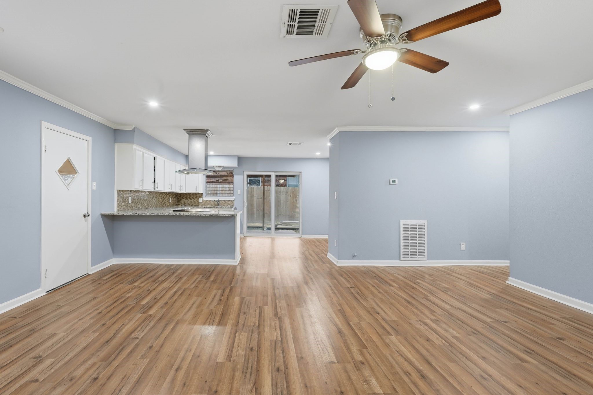 20 Moon Valley Court Conroe, TX 77304 - Photo 11 of 32 a view of kitchen with wooden floor a sink a refrigerator and window