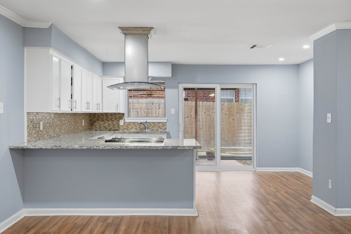 20 Moon Valley Court Conroe, TX 77304 - Photo 12 of 32 a kitchen with granite countertop a sink and cabinets