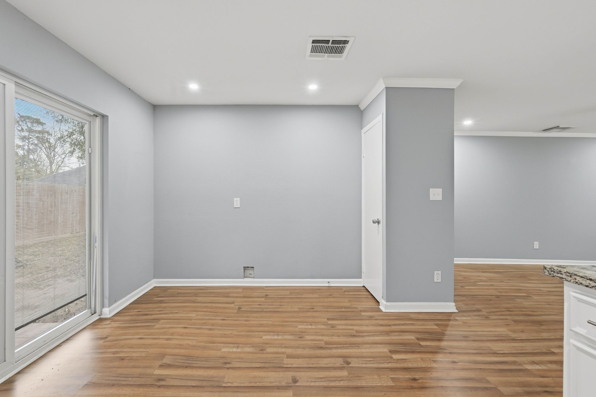 20 Moon Valley Court Conroe, TX 77304 - Photo 13 of 32 a view of an empty room with wooden floor and a window