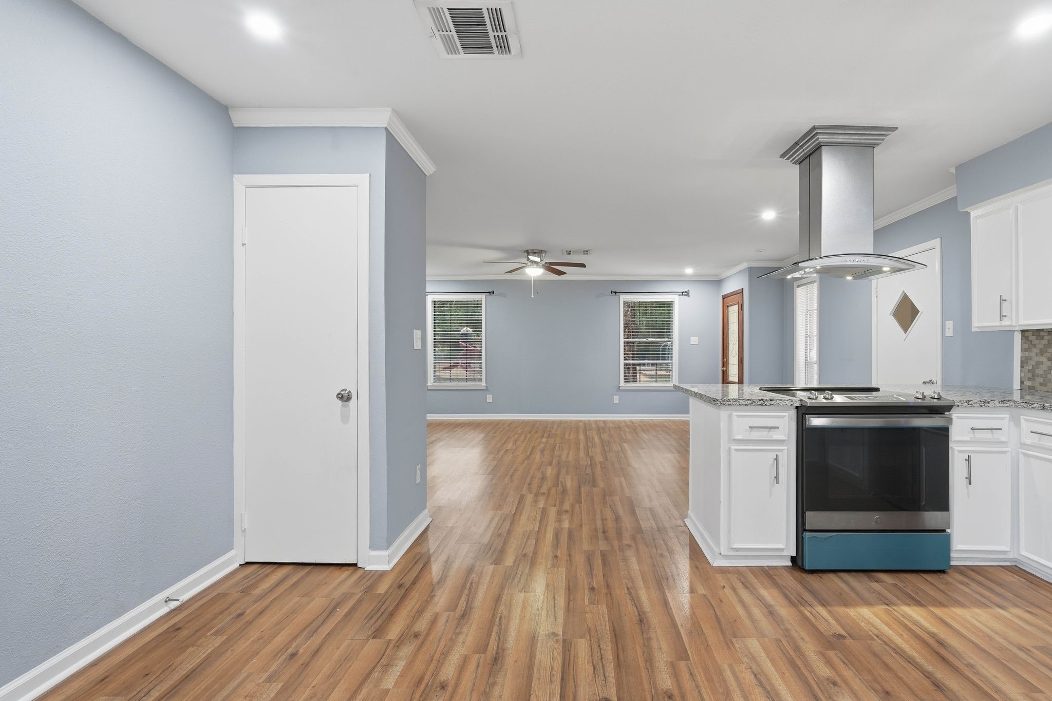 20 Moon Valley Court Conroe, TX 77304 - Photo 15 of 32 a view of a kitchen with wooden floor and stainless steel appliances
