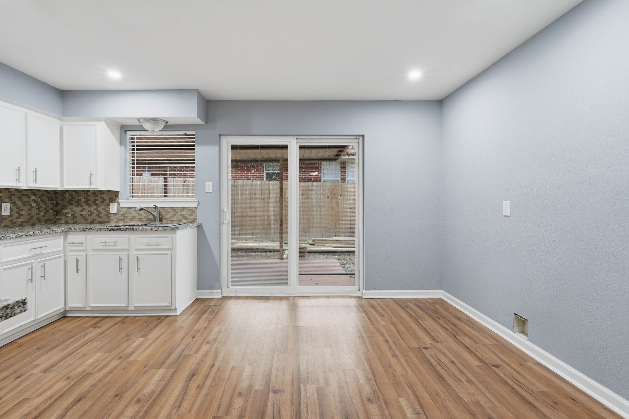 20 Moon Valley Court Conroe, TX 77304 - Photo 16 of 32 a kitchen with wooden floors and wide window