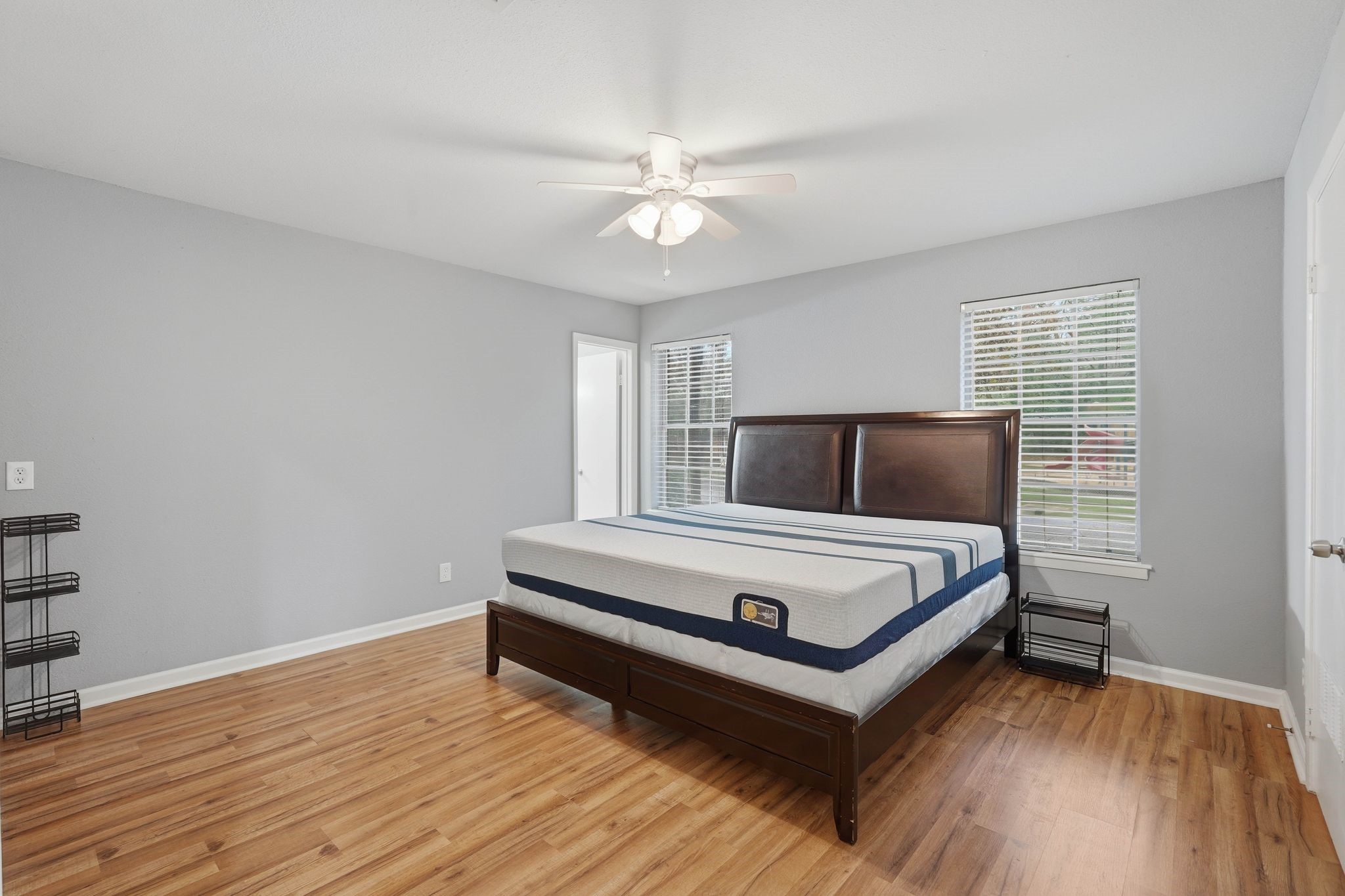 20 Moon Valley Court Conroe, TX 77304 - Photo 17 of 32 a white bed sitting in a bedroom next to a window