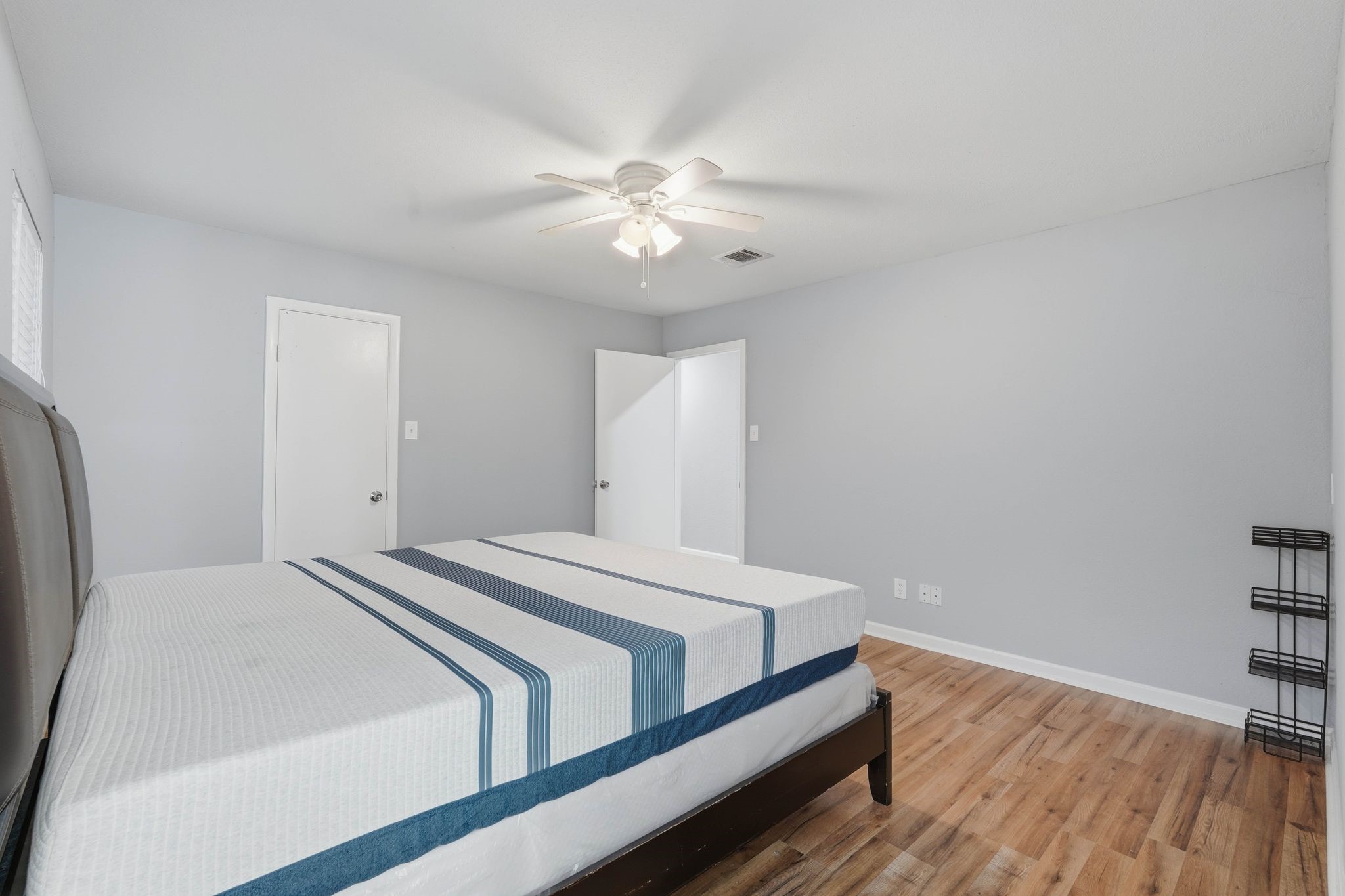 20 Moon Valley Court Conroe, TX 77304 - Photo 18 of 32 a bedroom with a bed and a chandelier