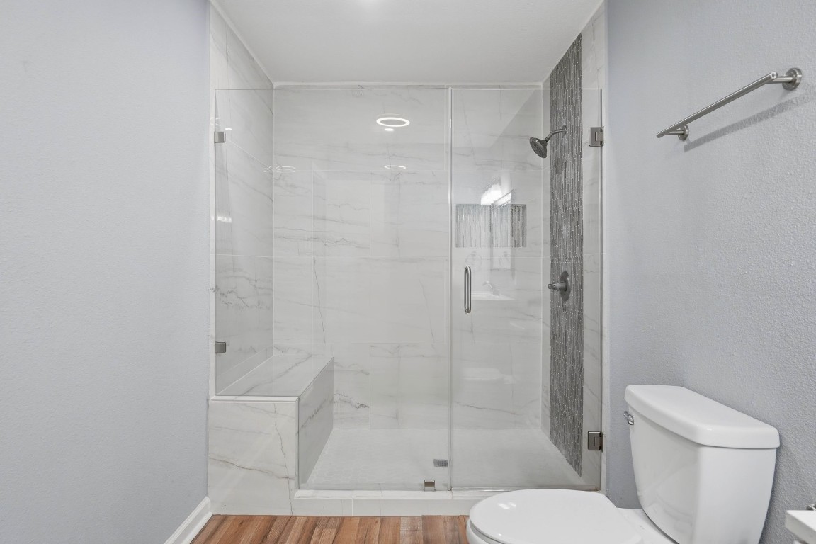 20 Moon Valley Court Conroe, TX 77304 - Photo 20 of 32 a bathroom with a shower and toilet
