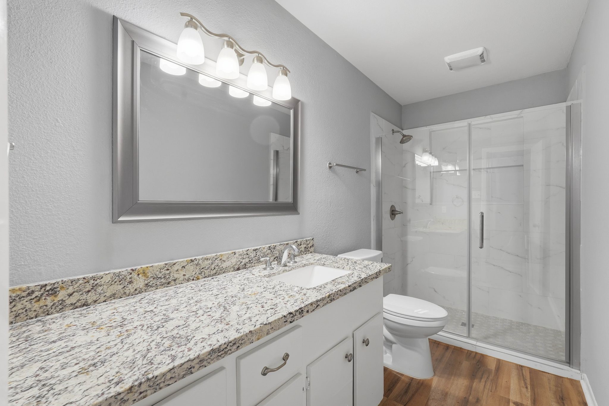 20 Moon Valley Court Conroe, TX 77304 - Photo 22 of 32 a bathroom with a granite countertop sink a toilet and shower