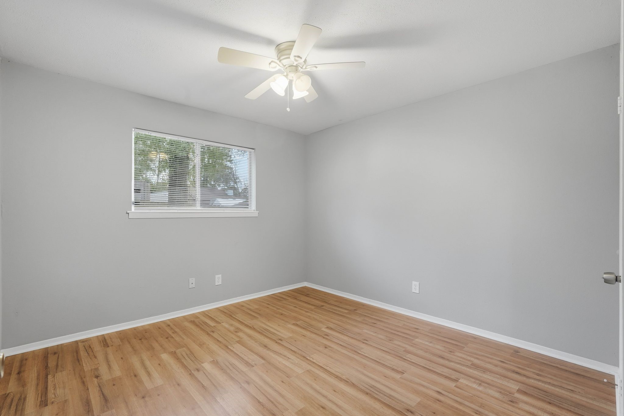 20 Moon Valley Court Conroe, TX 77304 - Photo 23 of 32 an empty room with wooden floor and windows