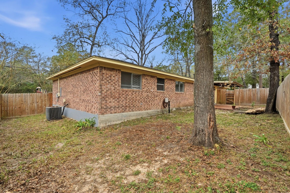 20 Moon Valley Court Conroe, TX 77304 - Photo 27 of 32 a front view of a house with a yard and garage