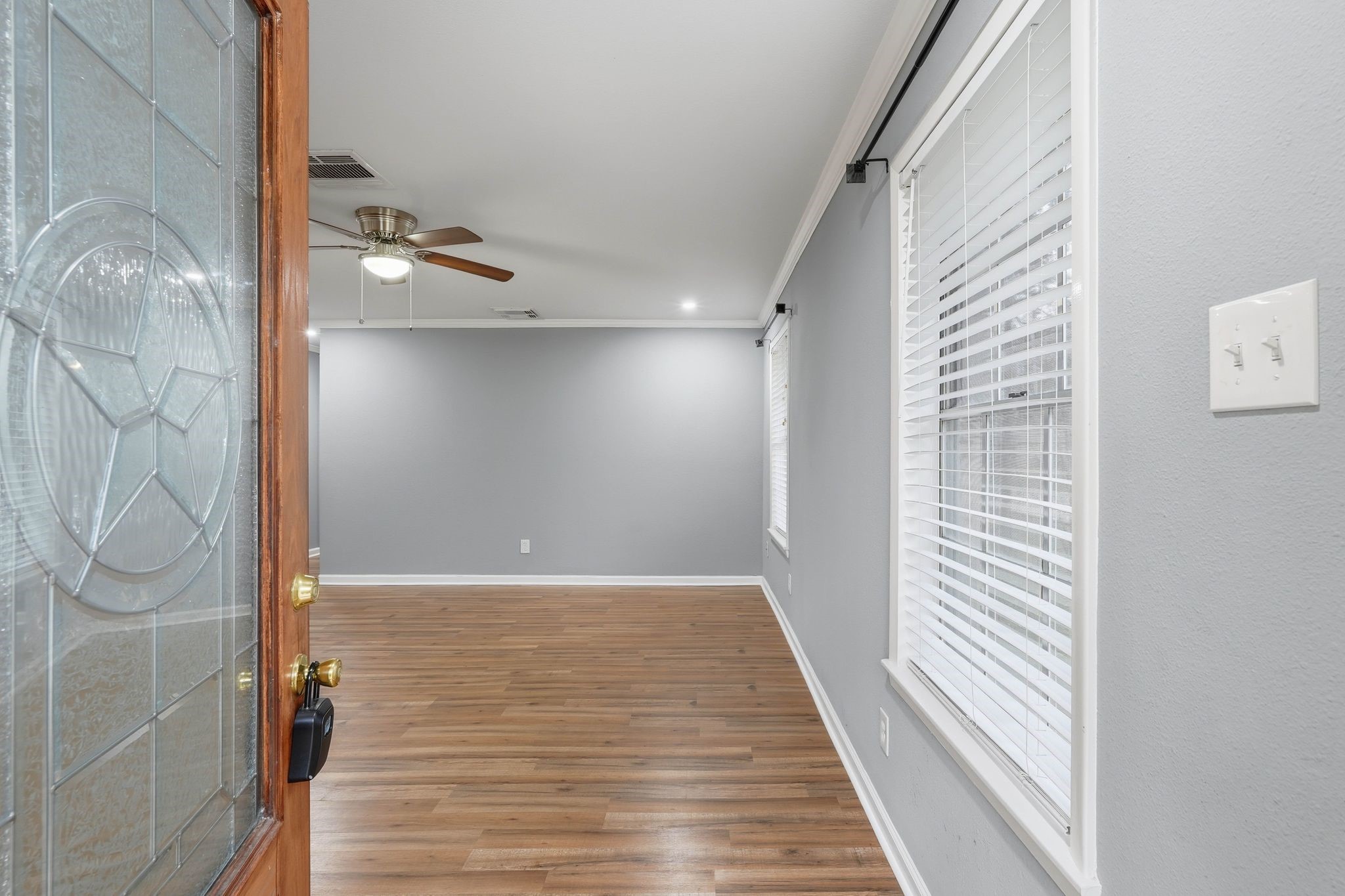 20 Moon Valley Court Conroe, TX 77304 - Photo 6 of 32 a view of a hallway with wooden floor and staircase