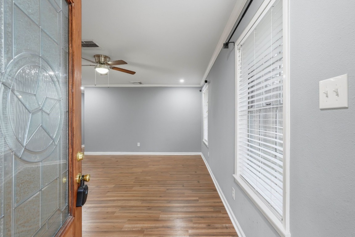 20 Moon Valley Court Conroe, TX 77304 - Photo 6 of 32 a view of a hallway with wooden floor and staircase