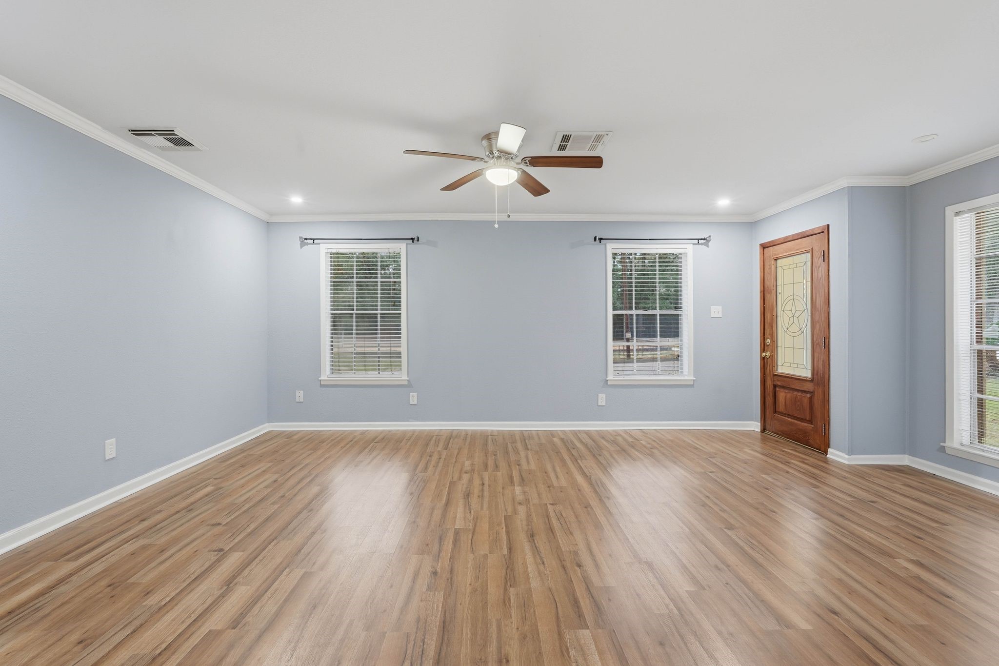 20 Moon Valley Court Conroe, TX 77304 - Photo 9 of 32 wooden floor in an empty room with a window