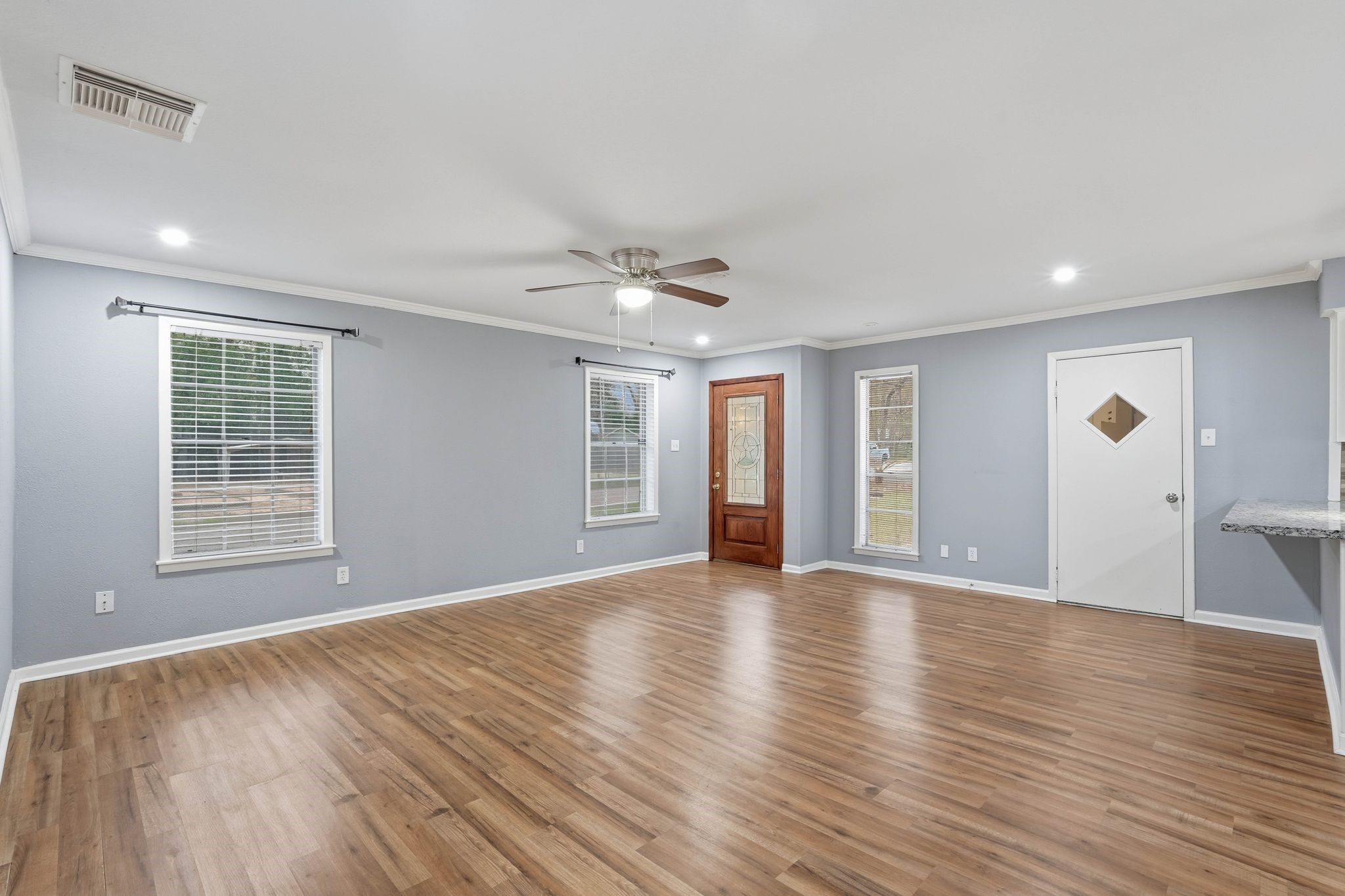 20 Moon Valley Court Conroe, TX 77304 - Photo 10 of 32 a view of an empty room with wooden floor and a window